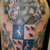 Coloured caban family crest tattoo on shoulder