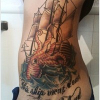 Coloured giant octopus attacking a ship tattoo on ribs