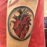 Coloured heart forearm tattoo by Iris Lys