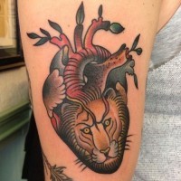Coloured heart of a lion tattoo by Paul Dobleman