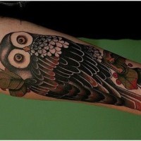 Coloured owl forearm tattoo