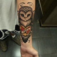 Coloured owl with heart forearm tattoo