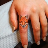 Coloured portrait of a fox tattoo on finger