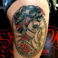 Coloured portrait of santa muerte girl tattoo on thigh
