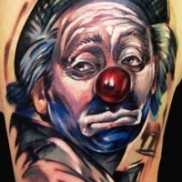 Coloured sad clown in a hat tattoo