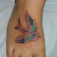 Coloured stylized bird tattoo on foot