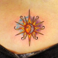 Coloured sun with moon tattoo on lower back