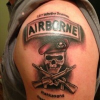Coloured symbol of us army tattoo on shoulder