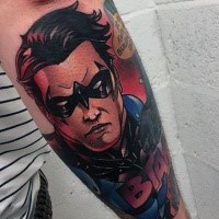 Comic books style colored arm tattoo of Batman and lettering