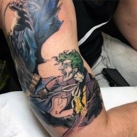 Comic books style colored shoulder and biceps tattoo of Batman and Joker