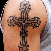 Cool 3D like black and white shoulder tattoo of antic cross