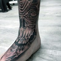Cool alien like big detailed black and white skull tattoo on ankle and foot