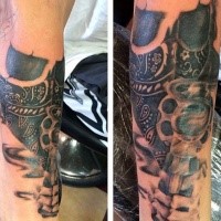 Cool black and gray style thug skull tattoo on forearm combined with revolver pistol