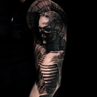 Cool black and white skeleton tattoo on shoulder