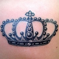 Cool black crown tattoo on shoulder