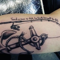 Cool black ink fishing rod with anchor and lettering tattoo on arm