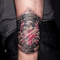 Cool black red family crest tattoo on wrist