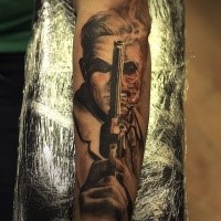 Cool breathtaking looking arm tattoo of half zombie half man with pistol