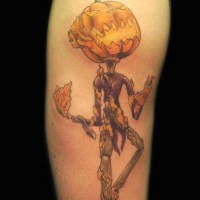 Cool designed and colored big monster pumpkin head monster in flames tattoo on arm