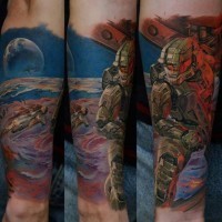 Cool designed and colored Halo video game themed tattoo on forearm with space soldier