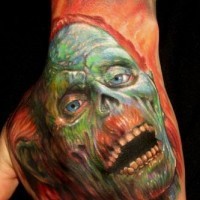 Cool detailed and painted colored zombie face tattoo on hand