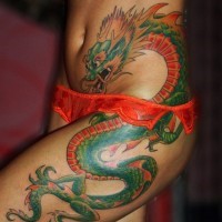 Cool idea of green dragon tattoo on hip for girls