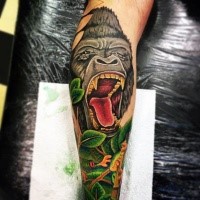 Cool illustrative style colored forearm tattoo of roaring gorilla nd tropical frogs