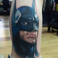 Cool illustrative style colored leg tattoo of Batman face