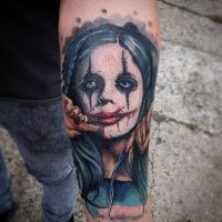 Cool Joker like colored portrait style forearm tattoo of evil woman