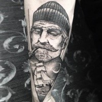 Cool looking black and white style old sailor with ship tattoo on forearm