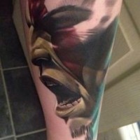 Cool looking colored forearm tattoo of angry barbarian face