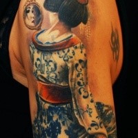 Cool looking colored shoulder tattoo of geisha woman with mirror