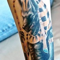Cool natural looking colored evil Seth God tattoo on forearm