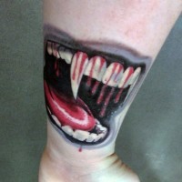 Cool painted bloody colored vampire teeth tattoo on wrist