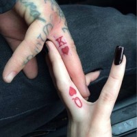 Cool red colored homemade couple tattoo on fingers