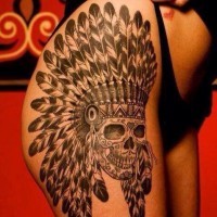Cool skull in an indian headdress tattoo on thigh