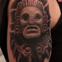 Cool stone head of a pagan deity tattoo on shoulder