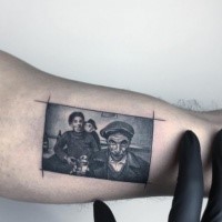 Creative looking black ink biceps tattoo of vintage portrait