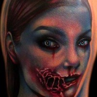 Creepy colored and detailed bloody zombie woman tattoo on shoulder