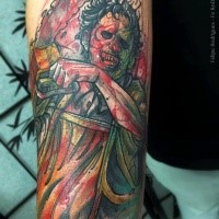 Creepy colored horror style arm tattoo of bloody maniac with chainsaw