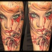 Creepy colored horror style forearm tattoo of bloody woman portrait