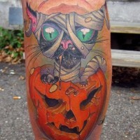 Creepy colored leg tattoo of mummy cat with pumpkin