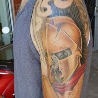 Creepy colored shoulder tattoo of dead Spartan warrior