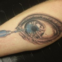 Creepy designed and painted big eye with needle tattoo on leg