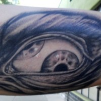 Creepy designed big black and white eye tattoo on arm