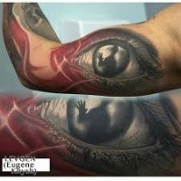 Creepy illustrative style biceps tattoo of eye with human silhouette
