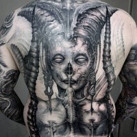 Creepy looking black and white whole back tattoo of demonic woman