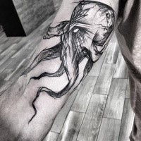 Creepy looking black ink painted by Inez Janiak biceps tattoo of demonic octopus