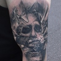 Creepy looking black ink shoulder tattoo of broken glass with monster face
