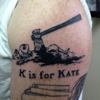 Creepy looking black ink shoulder tattoo of woman with axe and lettering